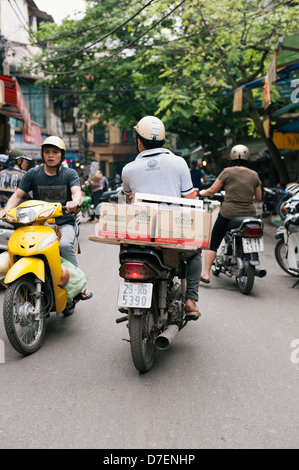 Hanoi, Vietnam - scooter traffic on the busy streets of the historic Old Quarter Stock Photo