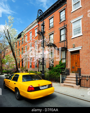 Yellowcab passes by Greenwich Village apartments in New York City. Stock Photo