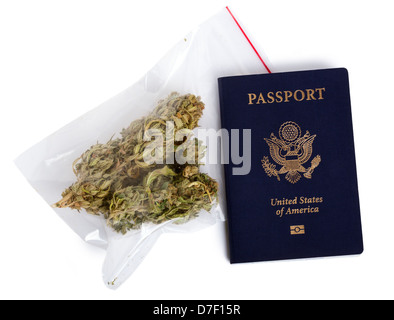 A USA passport and a zip-lock plastic bag containing marijuna buds isolated on white background. Stock Photo