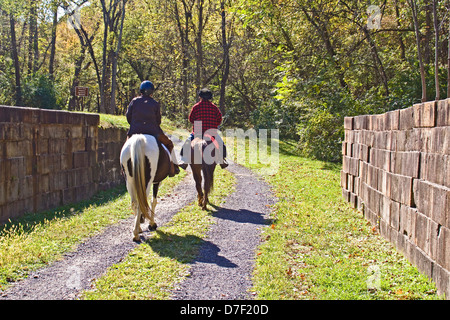 Two Equestrians crossing the Chesapeake and Ohio Canal Aqueduct at Fifteen Mile Creek. Stock Photo