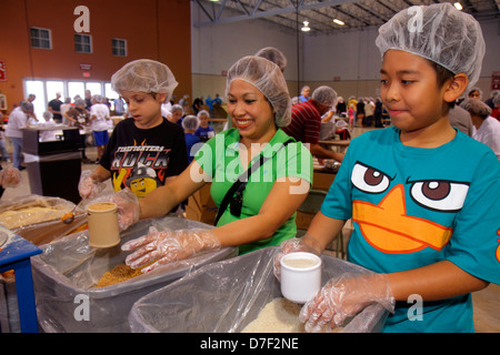 Miami Florida,Miami Dade County Fair & Expo,Feed My Starving Children,volunteer volunteers volunteering work worker workers,teamwork working together Stock Photo
