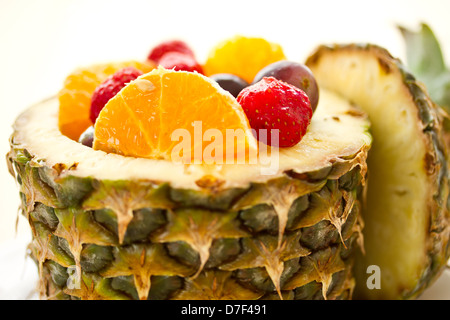 salad of pineapple, oranges and other fruits in a pineapple Stock Photo