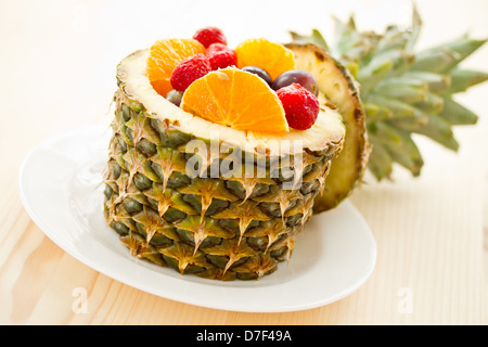 salad of pineapple, oranges and other fruits in a pineapple Stock Photo