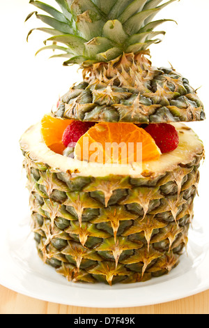 salad of pineapple, oranges and other fruits in a pineapple Stock Photo