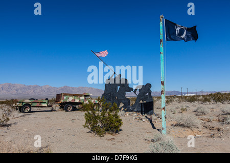 An Imo Jima War Memorial Replica on highway 62 in the California desert along with a POW flag. Stock Photo
