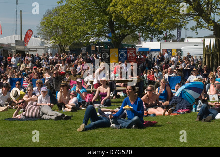 Badminton Horse Trials Gloucestershire UK. Some spectators watch the action on a large outdoor screen. 2013 2010s UK HOMER SYKES Stock Photo