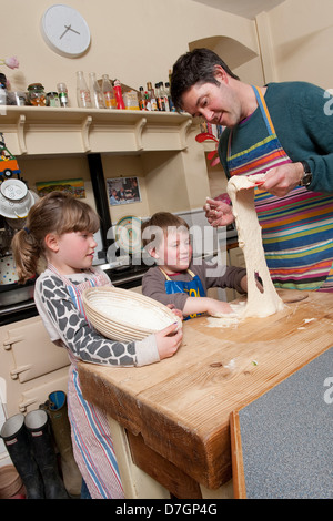 family making soda bread in kitchen Stock Photo