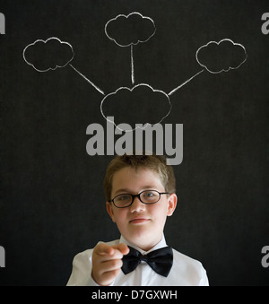 Education needs you thinking boy dressed up as business man with strategy thought chalk clouds on blackboard background Stock Photo