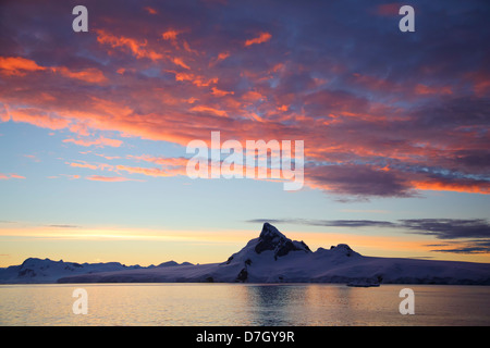 Sunset / sunrise as we travel below the Antarctic Circle, Antarctica.  Stock Photo