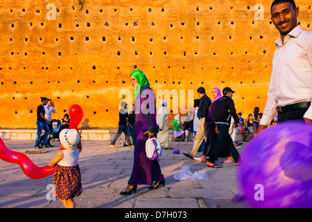Moroccan family on a holiday strolling around the clay walls of the Hassan Mosque in Rabat , Morocco Stock Photo