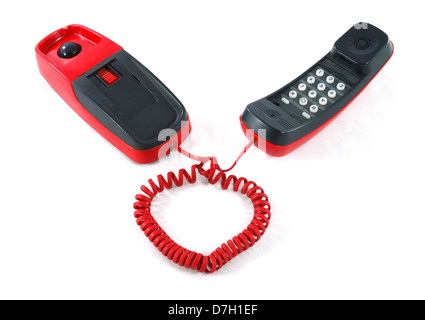 Little and old red and black phone with heart shaped cable Stock Photo