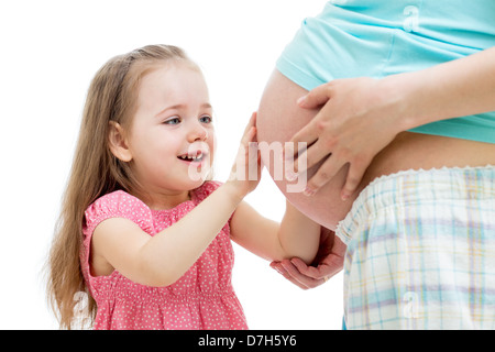 kid girl touches pregnant mother's belly isolated Stock Photo