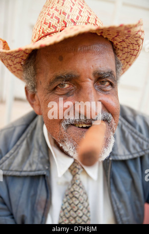 elderly man with hat, beard smoking cigar, Trinidad, Cuba, Caribbean Stock Photo