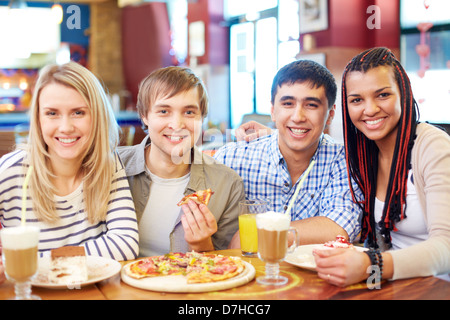 Image of teenage friends enjoying themselves in cafe Stock Photo