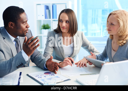 Pretty business interns listening to their team leader Stock Photo