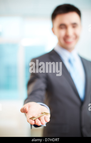 Hand of businessman holding key Stock Photo