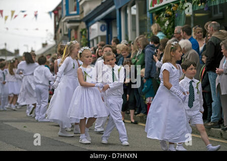 Helston, Cornwall, UK. 8th May 2013. Helston Flora day is held annually on the 8th May.  It is an ancient festival that celebrates the end of winter and mark the new spring season.  Shops and houses are decorated with floral displays.  Dances are held throughout the day and couples dance for miles along the city streets in and out of shops and houses, accompanied by the town band.  Once the big bass drum strikes at 7am the first dance commences. The childrens dance at 0940am. Credit:  Bob Sharples / Alamy Live News Stock Photo