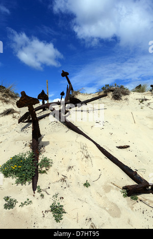 Collection of rusty anchors on Barril Beach, Tavira Island, Portugal Stock Photo