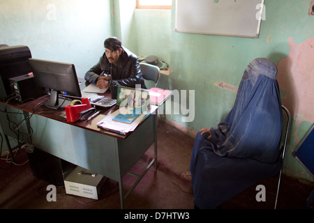 a woman reports domestic violence to the local police office in Afghanistan Stock Photo