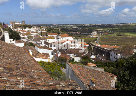 Rooftops and white buildings within the fortress walls of Óbidos a medieval town in Portugal Stock Photo