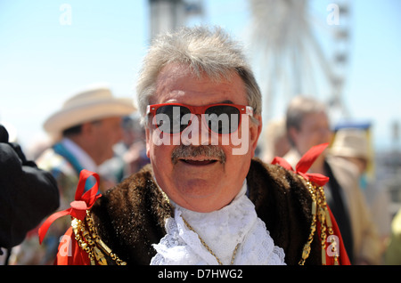 Mayor of Brighton Cllr Bill Randall of the Green Party wearing red sunglasses with his robes and chain of office Stock Photo
