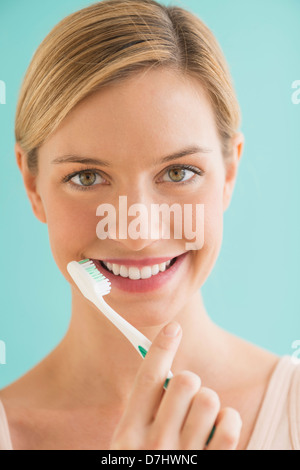 Portrait of woman brushing teeth Stock Photo