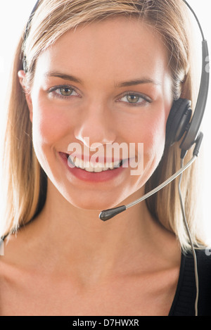 Studio portrait of young woman wearing headset Stock Photo