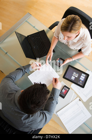 Business man and woman using mobile devices Stock Photo