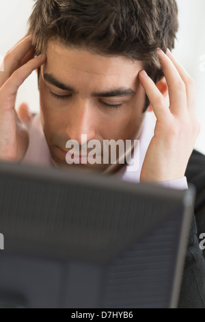 Business man with head in hands Stock Photo