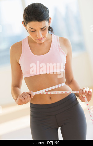 Woman measuring waist Stock Photo