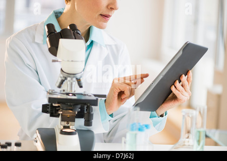 Woman using digital tablet in laboratory Stock Photo