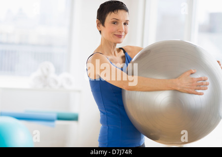 Portrait of mature woman exercising in gym Stock Photo