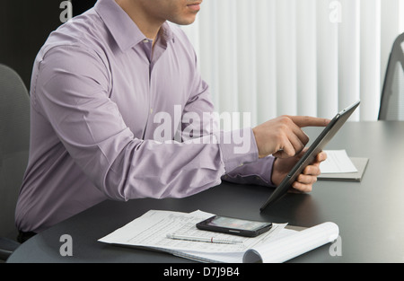 Male executive working at desk in office Stock Photo