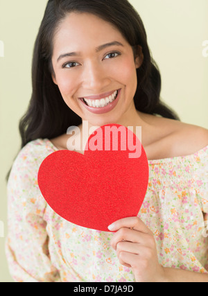 Young woman holding red paper heart Stock Photo