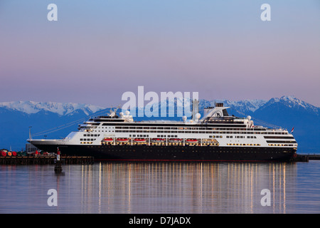 Cruise ship Statendam berthed at dock at dusk with Olympic mountains in background-Victoria, British Columbia, Canada. Stock Photo