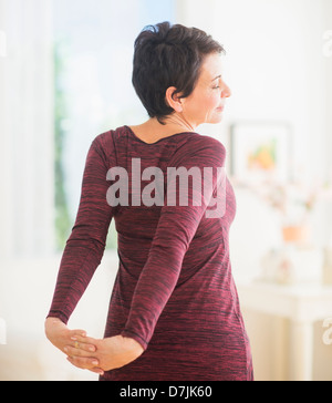 Mature woman stretching Stock Photo