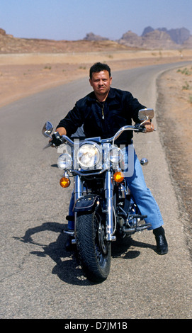 King Abdullah II of Jordan riding his motorcycle in Wadi Rum Stock Photo