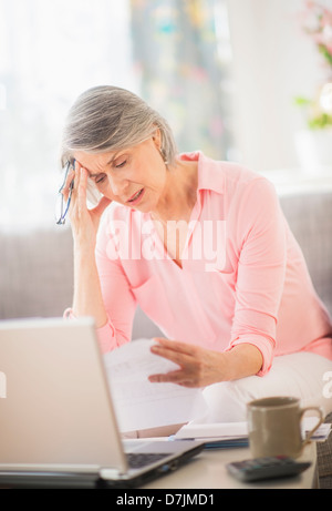 Portrait of uncertain woman doing paperwork Stock Photo