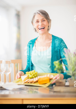 Portrait of woman holding appetizer plate Stock Photo