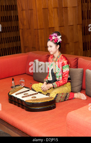 Thai girl playing khim Stock Photo