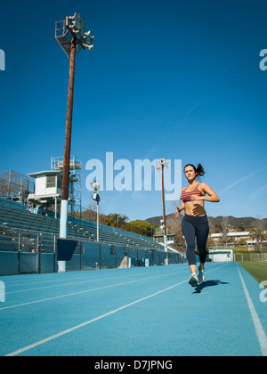 USA, California, Los Angeles, Woman running at sports field Stock Photo