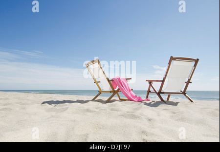 USA, Massachusetts, Nantucket, empty lounge chairs on sandy beach Stock Photo