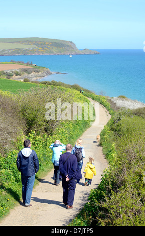 A family taking a walk along the south west coast path near padstow in Cornwall, UK Stock Photo