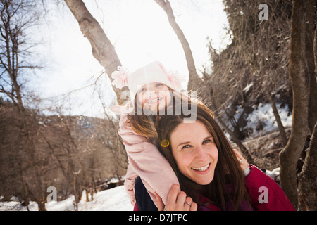 USA, Utah, Highland, Young woman carrying her daughter (2-3) on shoulders Stock Photo