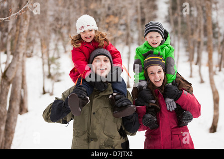 USA, Utah, Highland, Portrait of parents carrying children (2-3, 4-5) on shoulders Stock Photo