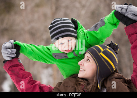 Portrait of young woman carrying boy (4-5) on shoulders Stock Photo