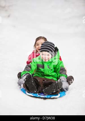 Portrait of two sledding children (2-3, 4-5) Stock Photo