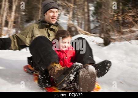 USA, Utah, Highland, Young man sledding with girl (2-3) Stock Photo