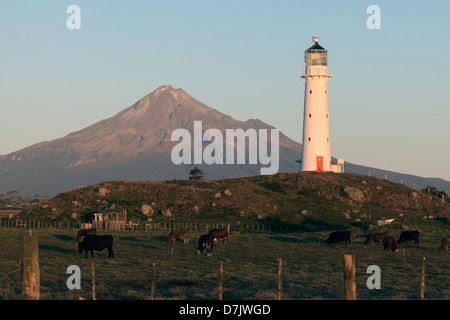 New Zealand, Plymouth, Mount Taranaki and lighthouse at sunset Stock Photo