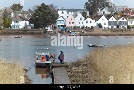 Passengers boarding the Topsham ferry on the banks of the river Exe with the village of Topsham, Devon, England, behind. Stock Photo